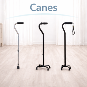 Three mobility canes including a single-point cane, quad cane, and offset cane displayed on a clean, light-colored floor with a white background.